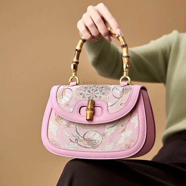 Song-Brocade-Pink-Mulberry-Silk-Handbag-Bamboo-Handle-Model-Seated Song-Brocade-Pink-Mulberry-Silk-Handbag-Bamboo-Handle-Model-Seated