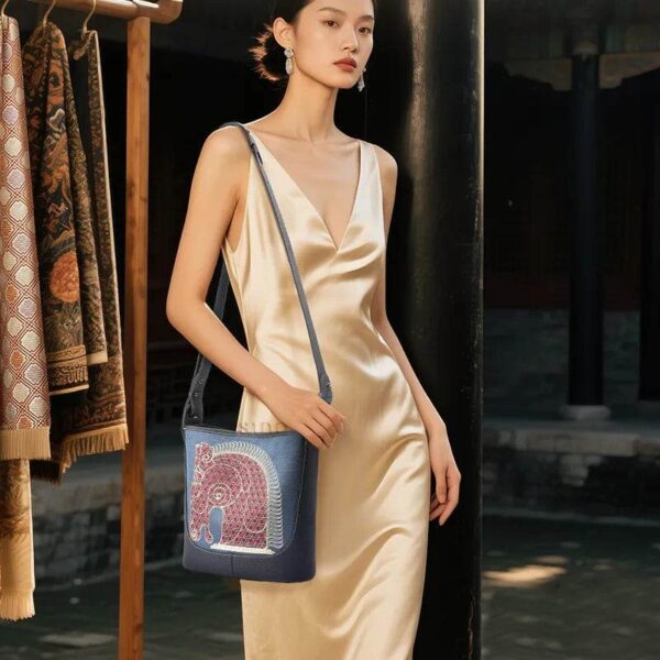 hinoiserie-horse-embroidered-leather-crossbody-bag-model-wearing-front-view hinoiserie-horse-embroidered-leather-crossbody-bag-model-wearing-front-view