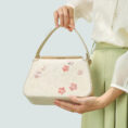 model-hand-holding-plum-blossom-bag