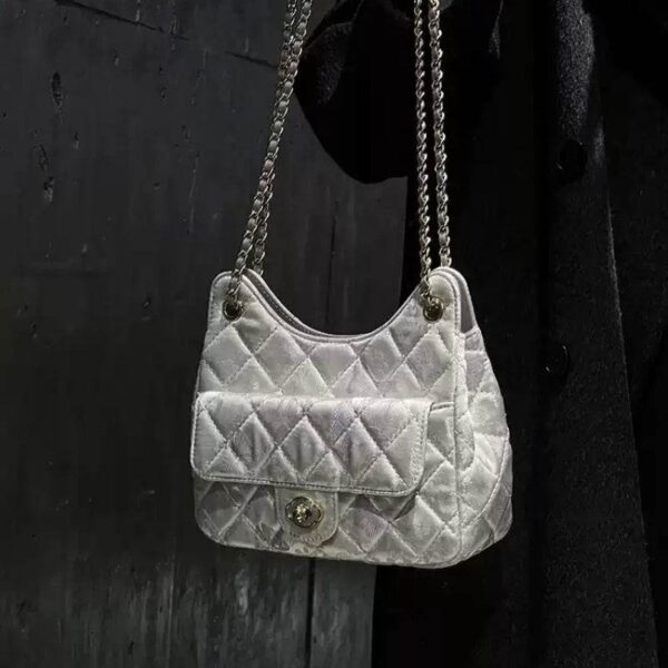 model-holding-chinoiserie-gold-brocade-underarm-bag model-holding-chinoiserie-gold-brocade-underarm-bag